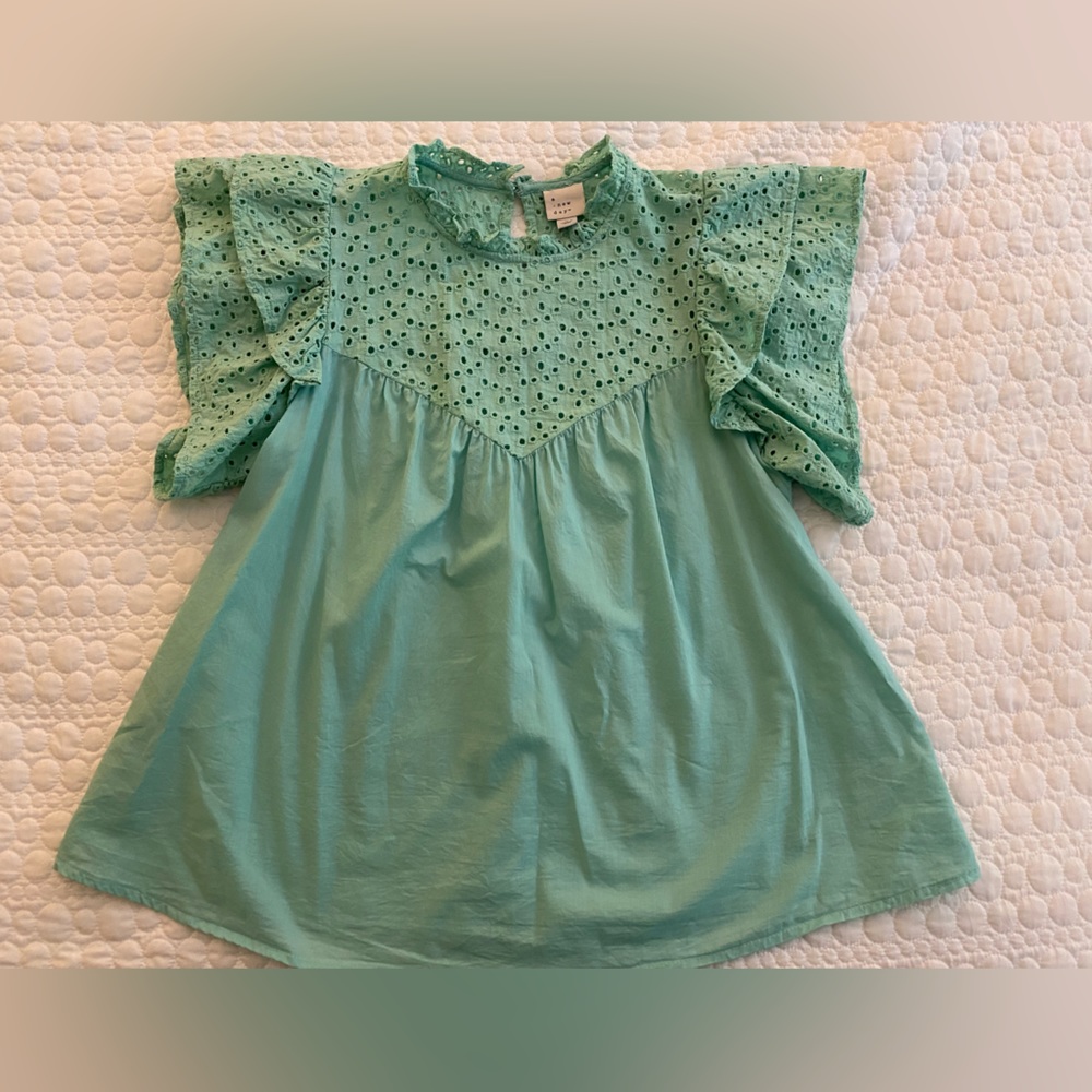 Turquoise eyelet top. Flutter sleeve.